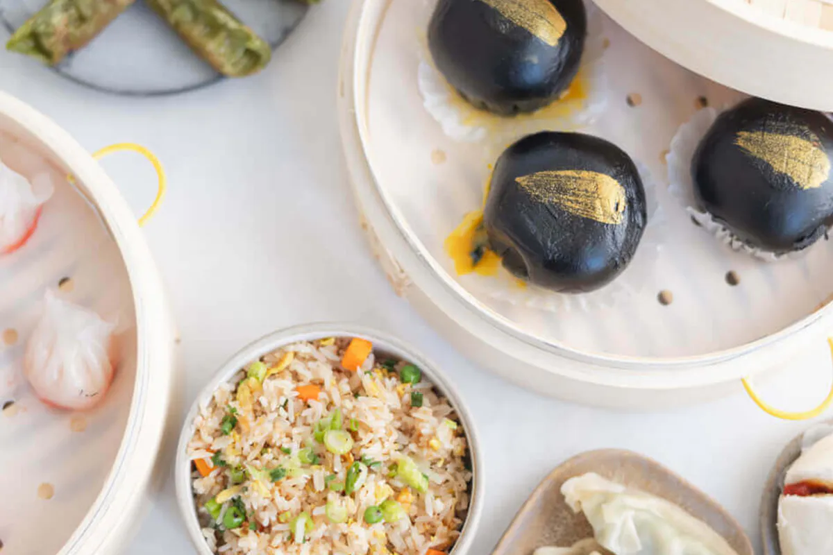 Assorted dim sum platter with black lava buns, har gow and vegetable fried rice at One More Bite Dumpling, a Chinese Restaurant in Palm Desert