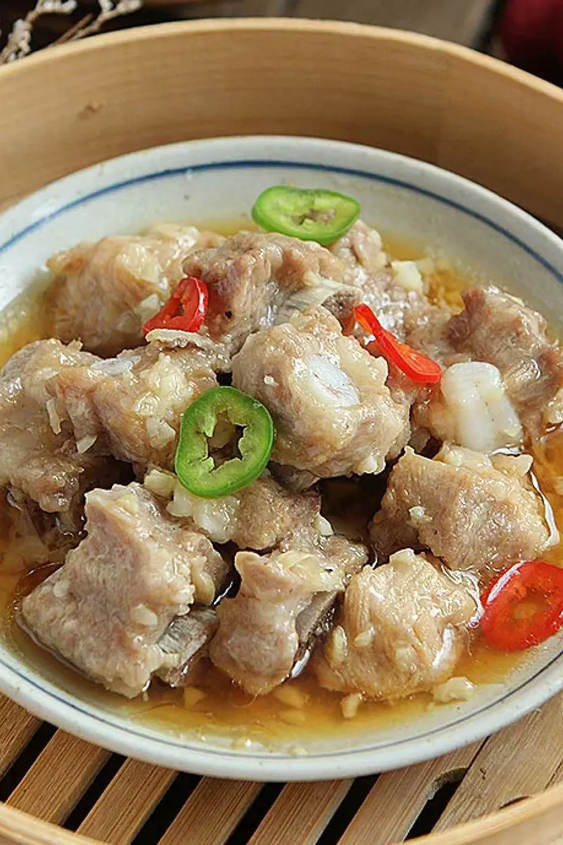 Steamed garlic spare ribs garnished with sliced green and red chili peppers at One More Bite Dumpling, a Chinese Restaurant in Palm Desert