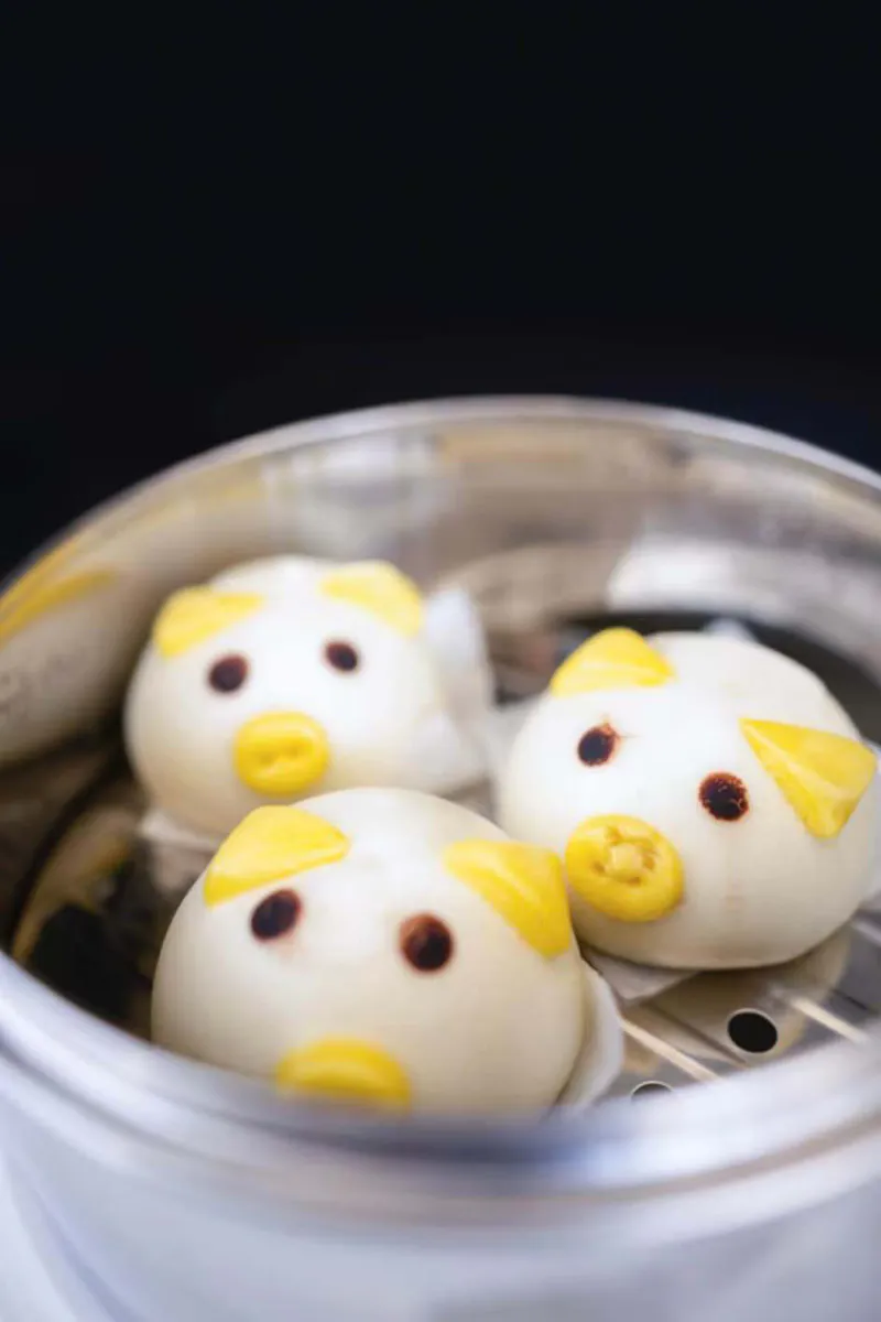 Cute pig shaped steamed buns inside metal steaming pot at One More Bite Dumpling, a Chinese Restaurant in Palm Desert
